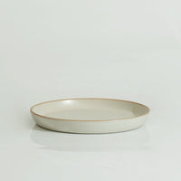 A white ceramic 10'' diameter plate with a swirl pattern on a white background.