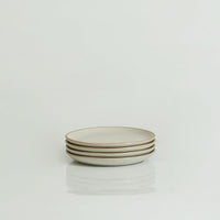 A stack of flat lip plates in marshmallow white with speckles, displayed against a white background.